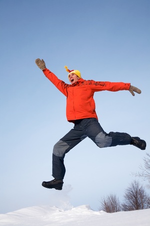  young guy jumps with joy in the winterの写真素材