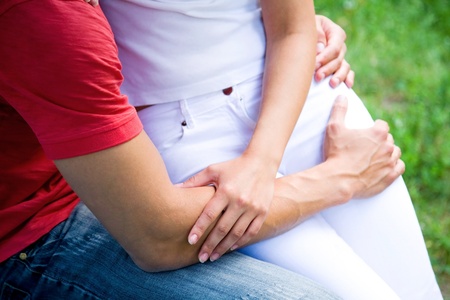two pairs of hands in love tenderly hold together