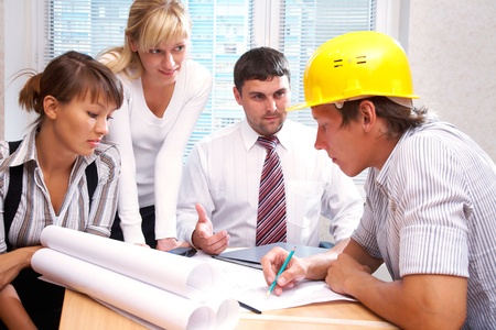 Meeting the team of engineers working on a construction project at the tableの写真素材