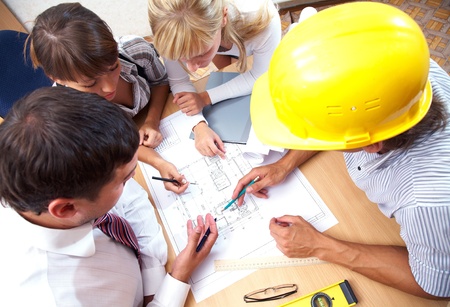 Meeting the team of engineers working on a construction project at the table. Up viewの写真素材