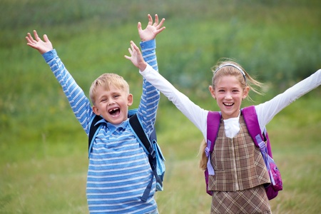 portrait of  boy with girl joyful laugh and throw their hands up
