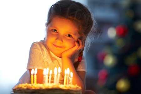 Portrait of little pretty girl with birthday cake