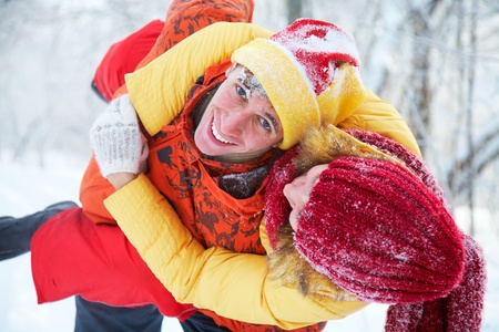  young family plays winter wood on snow 
