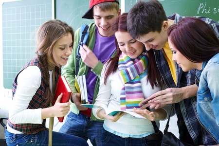 Group of students discussing in classroomの写真素材