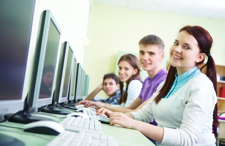 group of young students studying in the classroom with computer 