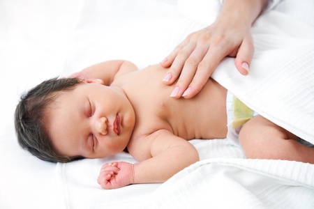 Portrait of newborn baby in careful mothers hands の写真素材