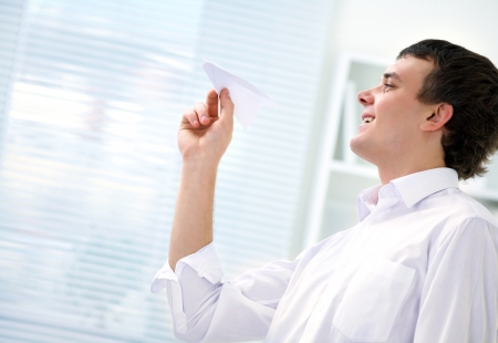 young businessman starts  paper airplane in the officeの写真素材