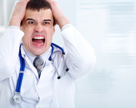 Portrait of male doctor having bad newsの写真素材