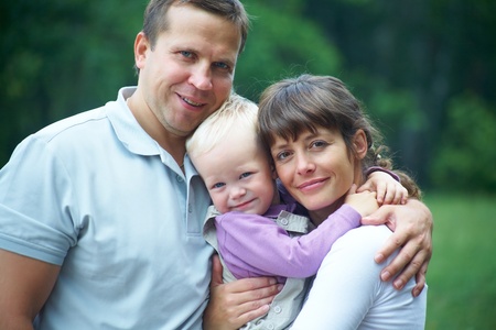 Happy couple with their little son having good time together 