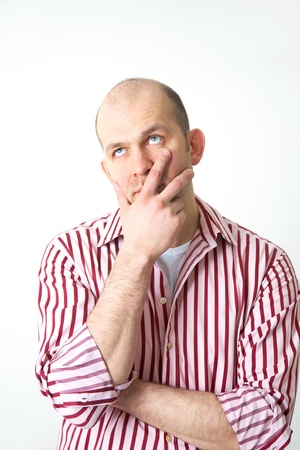 handsome young man in search of decision scratching his headの写真素材