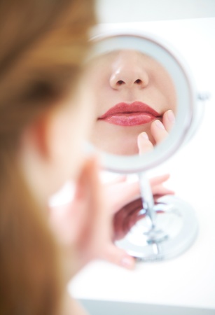 reflection in the mirror a beautiful young womanの写真素材