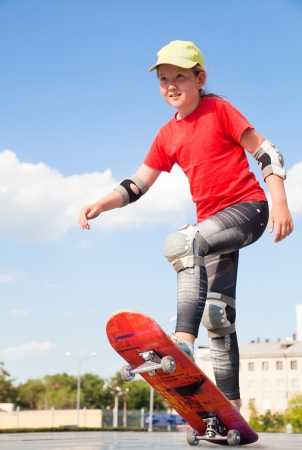 little sweet girl  rides on  skateboardの写真素材