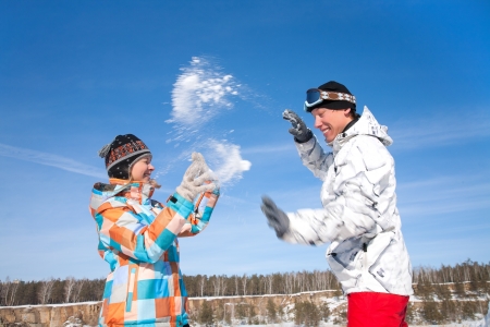 Young playful couple having fun in the snowの写真素材
