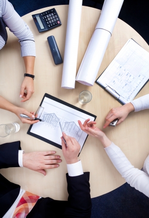Hands of business people at the table at the meeting in the office  top viewの写真素材