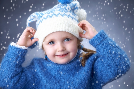 Portrait of little winter girl with snowflakesの写真素材