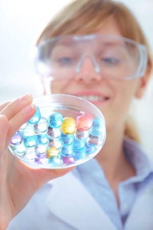 Medical or scientific researcher or doctor using looking at a solution in a laboratory の写真素材