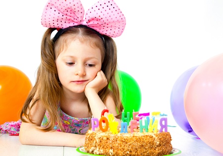 Portrait of cute little girl with birthday’s cake