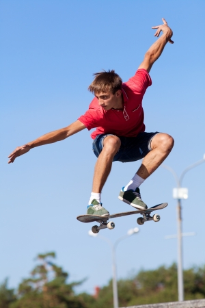 cool skateboard is jumping high in air の写真素材