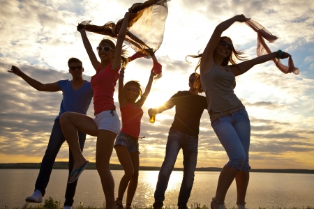Large group of young people enjoying a beach partyの写真素材