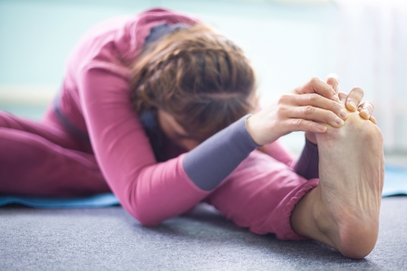 Woman practicing yoga at health clubの写真素材