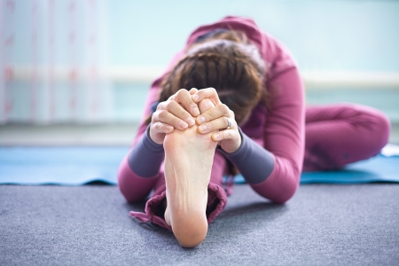 Woman practicing yoga at health clubの写真素材