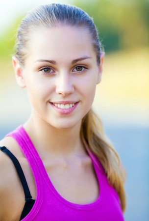 portrait of young sporty woman outdoorの写真素材