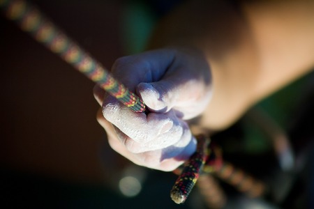 Magnesia hand climber on the rope. close up 