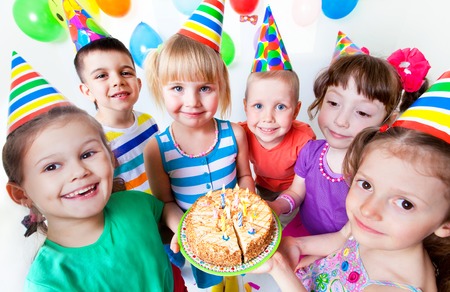 group of children at birthday party with cakeの写真素材
