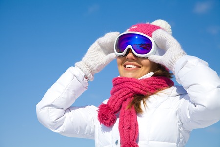 portrait of young smilling woman  on winter holiday outdoorの写真素材