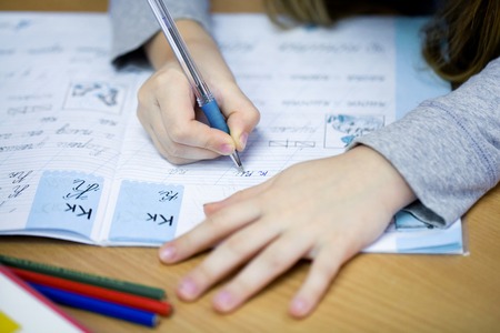 hands pishushih schoolgirl in a notebook at schoolの写真素材