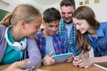 group of young students studying in the classroom with tabletの写真素材