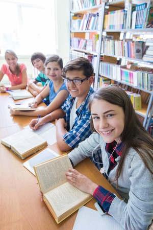 group of students engaged in learning at the desk in the libraryの写真素材