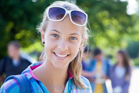 
young girl student on a background of green parkの写真素材