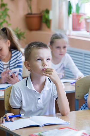 schoolchildren sit at their desks in elementary schoolの写真素材