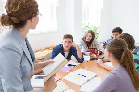 group of students listening to the teacher in the classroom at schoolの写真素材
