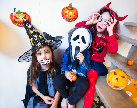 Children in monster costumes have fun on a Halloween holidayの写真素材
