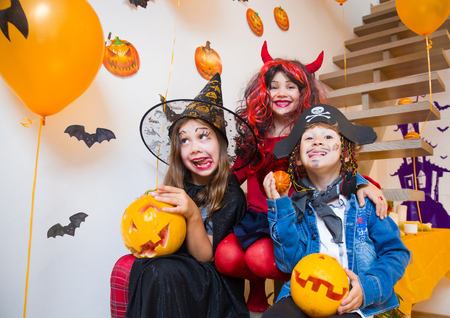 Little kids in  costumes on a Halloween partyの写真素材
