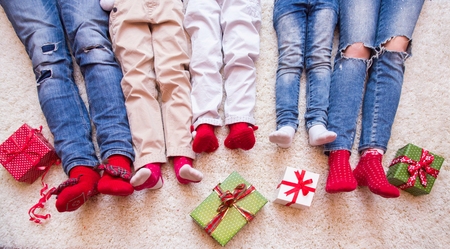 happy family celebrating Christmas near the fireplace under the Christmas tree. Legsの写真素材