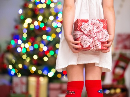 Hands of little girl with Christmas presentの写真素材