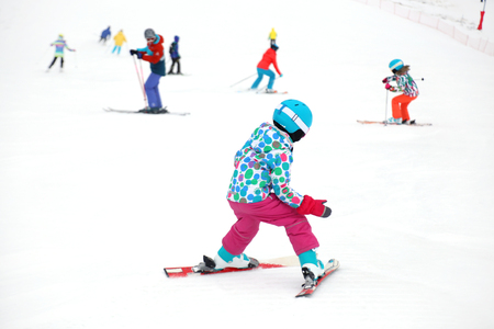 little girl learns to ski in the winter resortの写真素材