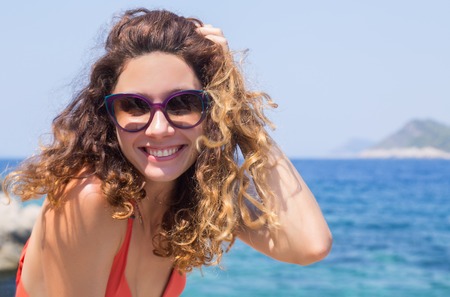Portrait of young pretty woman having good time on sea. Bikini. Beach.の写真素材