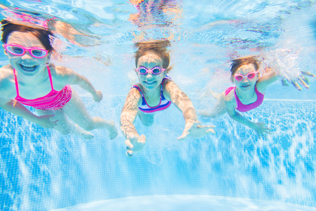little kids swimming  in pool,  underwater photo,の写真素材