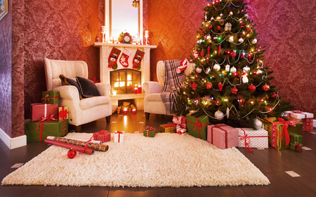 Festively decorated apartment with fireplace and Christmas treeの写真素材