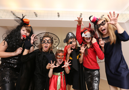 group of funny  children in costume celebrate together a halloween partyの写真素材