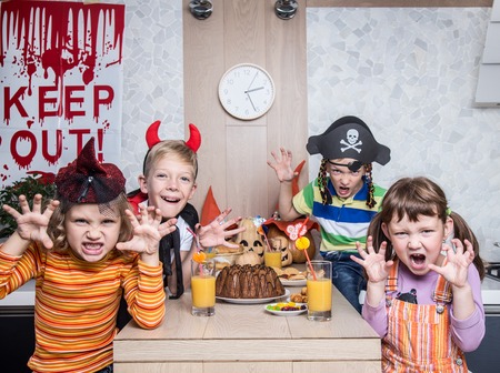 group of funny  children in costume celebrate together a halloween partyの写真素材