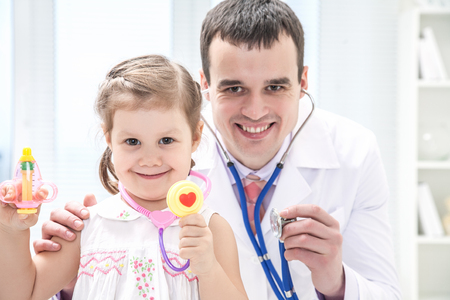 portrait of little girl with pediatric doctorの写真素材