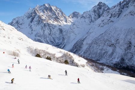 view of the mass of people skating on a ski slope in the mountains at ski resortの写真素材