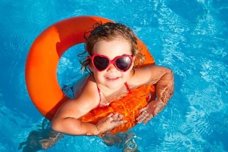little girl swim in  poolの写真素材