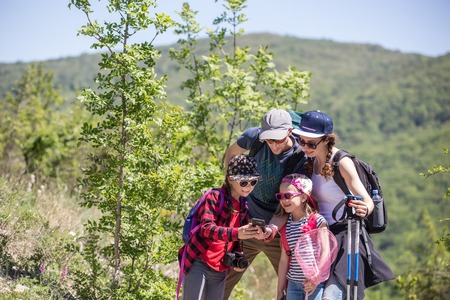 Family with two daughters travels along a beautiful path in the forestの写真素材