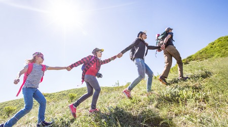 family with two kids have hiking  through the mountainsの写真素材